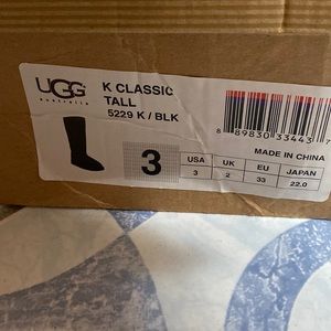 Tall black boot  Uggs.